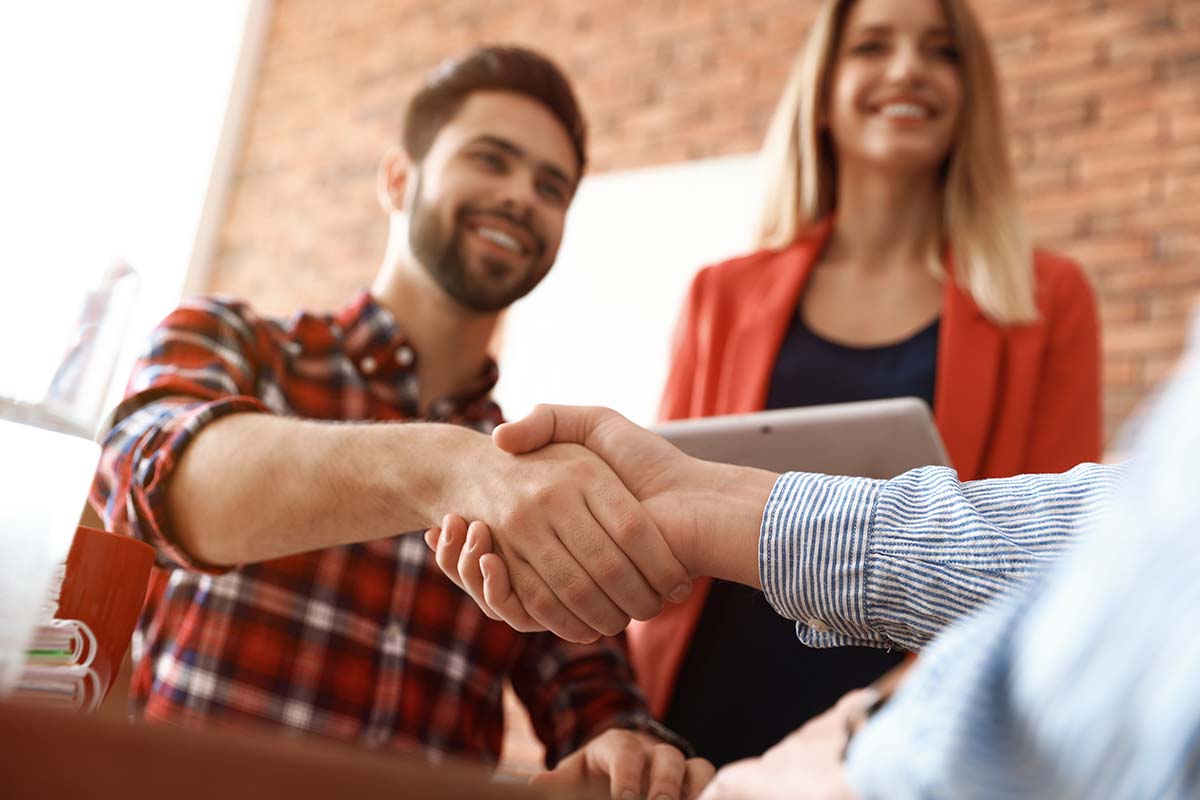 man shaking another's hand after learning why good addiction centers connect clients to aa or na