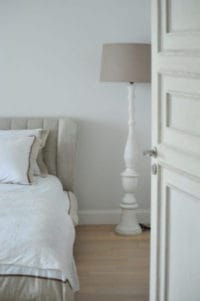 bed lamp and open door in a boardprep recovery residence