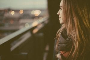 woman smiles on bridge after personalized care for mental health and addiction