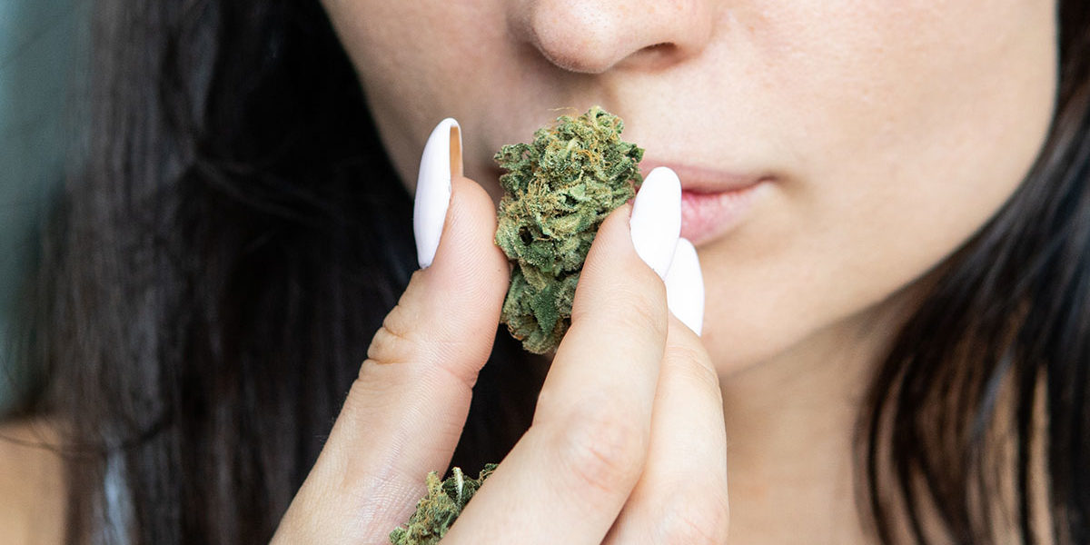woman smelling marijuana wondering what is marijuana
