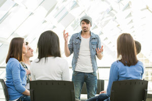 man sharing story in group therapy in a Heroin Detox program for professionals