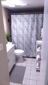 updated bathroom with tiled floor at boardprep recovery