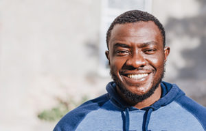 african american man outside smiling after dialectical behavior therapy session for addiction treatment 