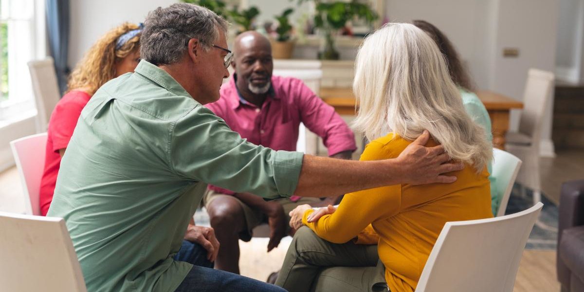 Folks in group therapy talking about depression and alcohol addiction
