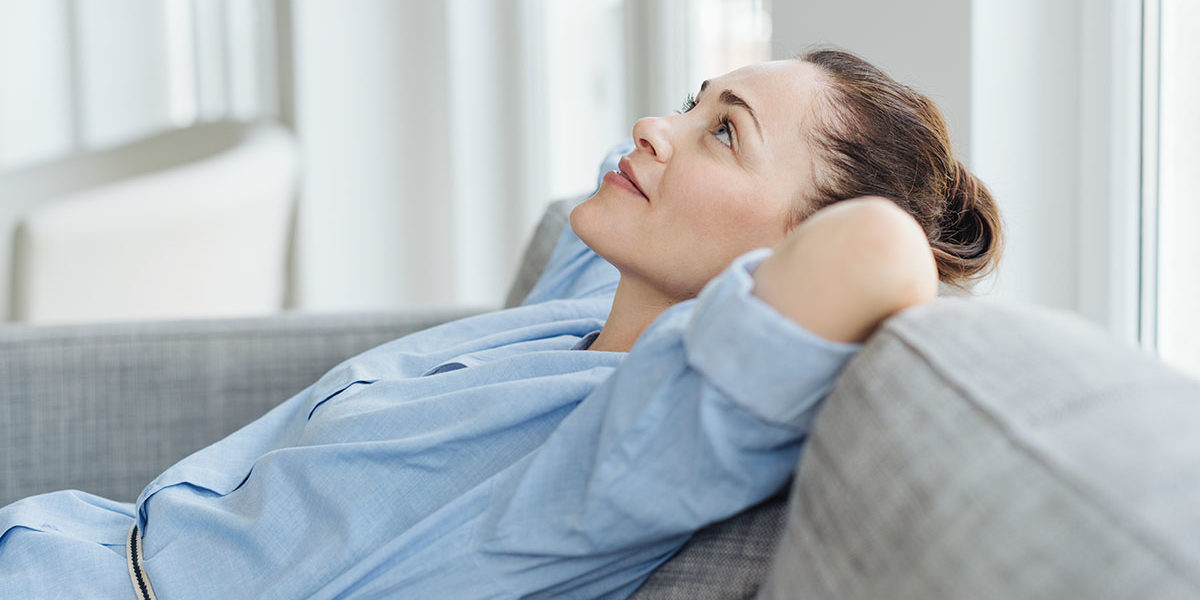 woman leaning back on couch looking up and managing triggers
