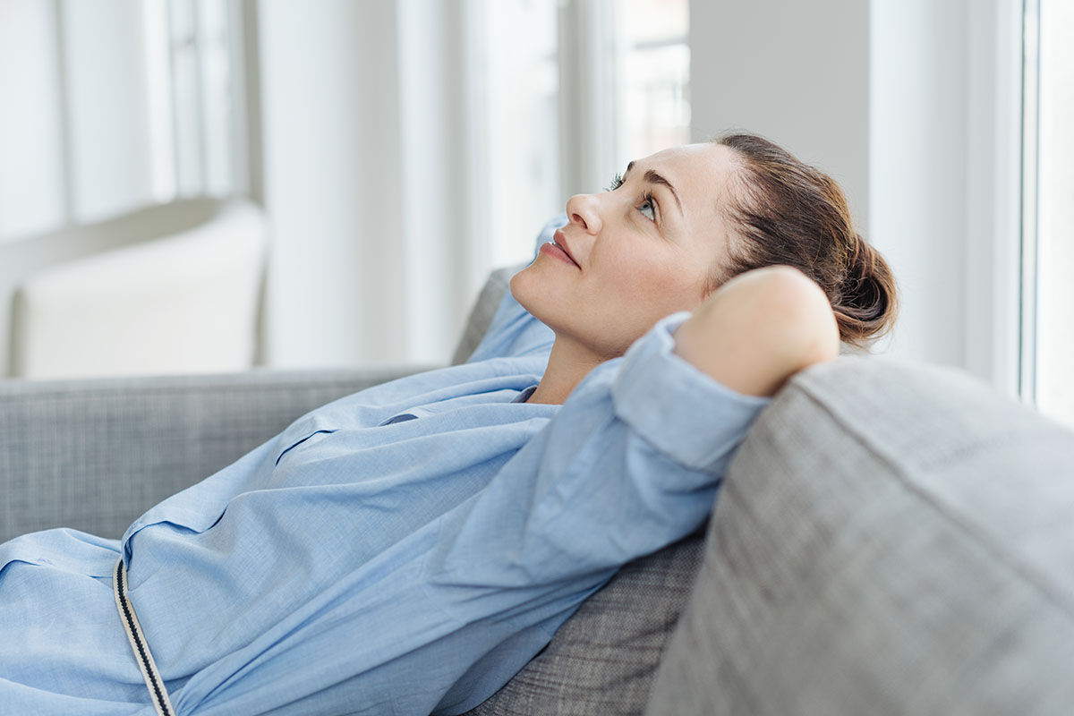 woman leaning back on couch looking up and managing triggers