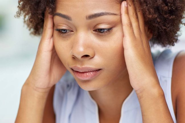 woman starting to panic trying to concentrate on the links between stress and addiction