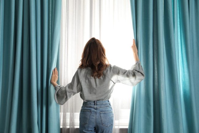 More Will Be Revealed woman pulling back curtains to reveal addiction recovery