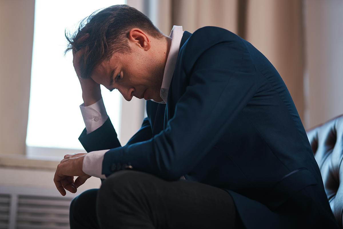 disheveled businessman dealing with drinking and drug use