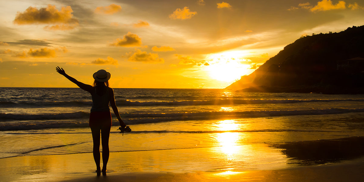 person walking along the beach practicing patience in recovery