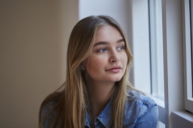 woman gazing out window ready for addiction recovery