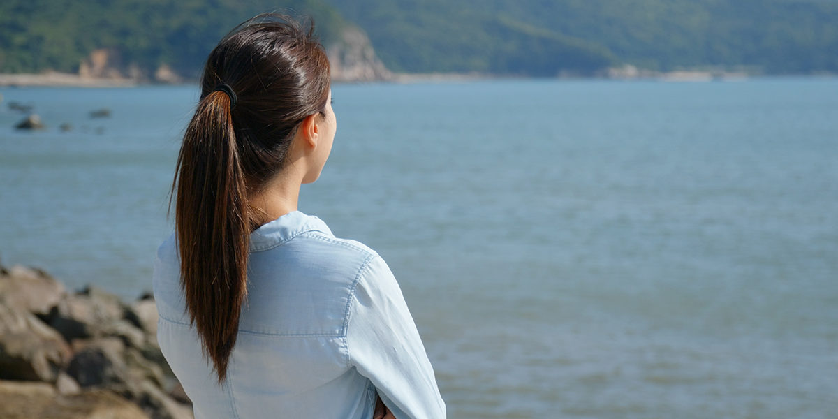 Two Undeniable Ways in which Addiction Does NOT Discriminate- Who & How woman looking at the ocean thinking how addiction does not discriminate