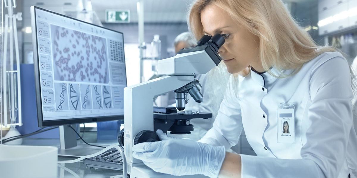 woman using microscope to see genetic influence in alcohol use disorder