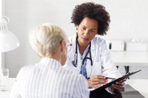 doctor consulting with a new female client for PHP for Health Professionals