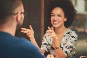 a woman talks to a man about entering a drug rehab for health professionals in jacksonville florida