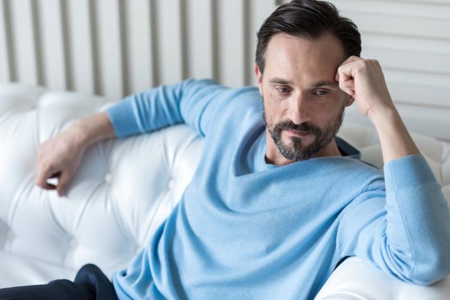 Risks of quitting alcohol cold turkey Man thinking about quitting alcohol cold turkey