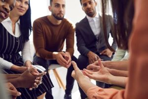 people in a heroin addiction rehab treatment program participate in group therapy 