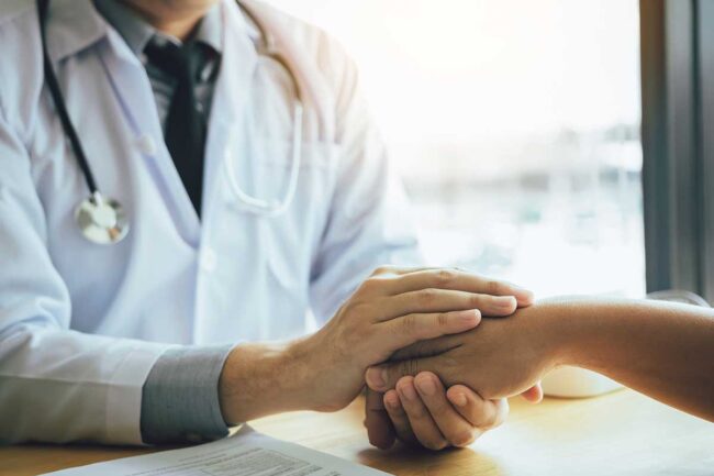 Treating Opioid Abuse A therapist comforts a patient suffering from opioid abuse