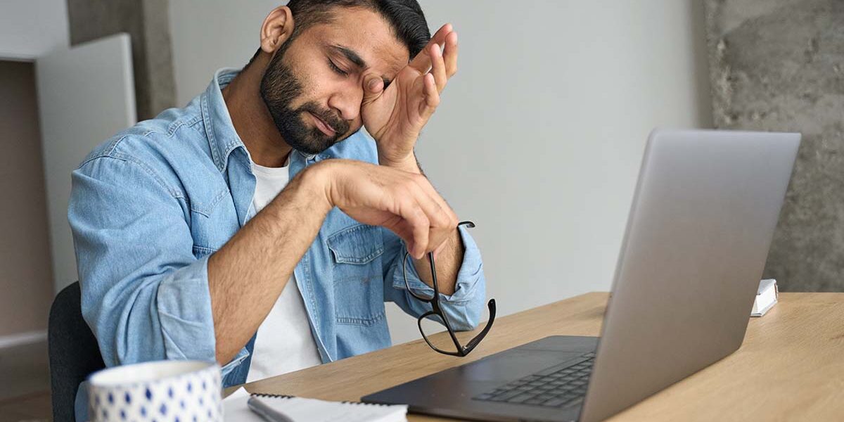 A man dealing with alcohol and burnout in the workplace