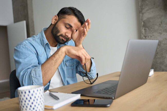 Using Alcohol to Deal with Burnout A man dealing with alcohol and burnout in the workplace