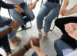 Hands of people sitting in a circle at a heroin rehab in Tampa